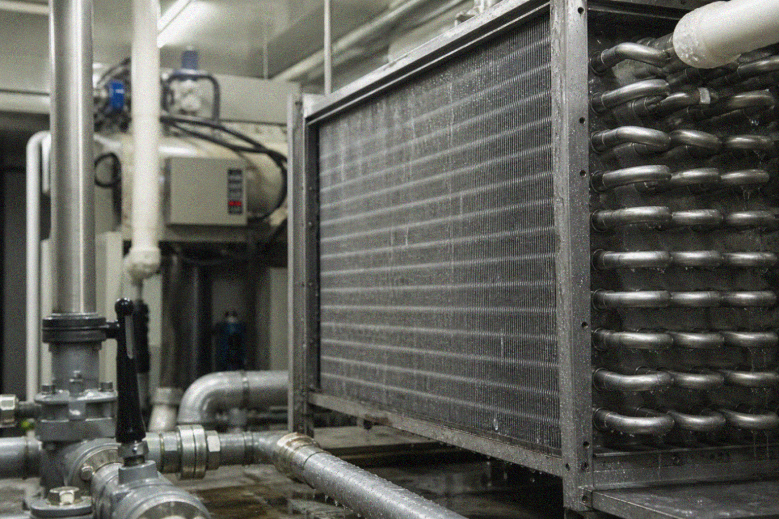 Industrial atmospheric water condenser with droplets on stainless coils